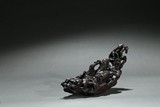 AN AGARWOOD 'ZHANG QIAN IN HOLLOW LOG' CARVING 