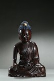 A PAINTED AGARWOOD BUDDHA FIGURE