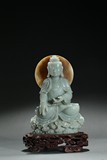 A GREENISH-WHITE JADE CARVED SHAKYAMUNI STATUE