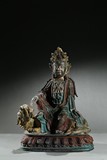 A BRONZE PAINTED FIGURE OF MANJUSRI ON LION