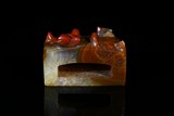 A CARNELIAN AGATE CARVED SWORD SLIDE