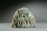 A GREENISH-WHITE JADE MOUNTAIN BOULDER