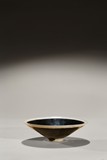A BLACK GLAZED CONICAL BOWL