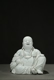 A DEHUA WHITE GLAZED FIGURE OF MAITREYA