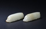 A PAIR OF WHITE JADE 'PIGS' CARVINGS