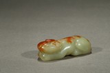 A YELLOW JADE RECUMBENT BEAST PAPER WEIGHT