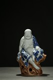 A BLUE AND WHITE CERAMIC MAITREYA 