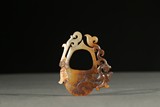 A MOTTLED RUSSET AND CELADON JADE CHILONG PENDANT 