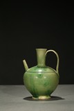 A GREEN GLAZED POTTERY EWER