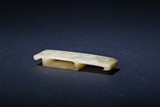 AN ARCHAIC WHITE JADE 'CHILONG' SWORD SLIDE