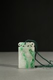 A JADEITE CARVED 'CRANE AND PINE' PENDANT