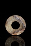 A MOTTLED WHITE AND RUSSET JADE DISC BI