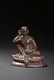 AN AGARWOOD CARVING OF SEATED MILAREPA 