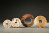 A GROUP OF FOUR JADE DISCS 