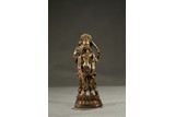 A GILT-BRONZE FIGURE OF STANDING DEITY