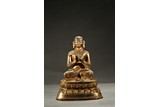 A GILT-BRONZE FIGURE OF GURU