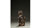 A PARCIL-GILT BRONZE CAST BUDDHIST LION