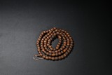 A SANDALWOOD CARVED BEAD NECKLACE