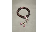 AN AGARWOOD AND TOURMALINE ROSARY BRACELET
