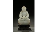A WHITE JADE CARVED AMITABHA ON ZITAN STAND