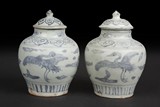 A PAIR OF BLUE AND WHITE 'CRANES' SMALL JARS WITH COVERS