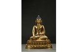 A GILT-BRONZE FIGURE OF SHAKYAMUNI
