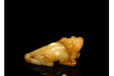 A YELLOW JADE CARVING OF MYTHICAL BEAST