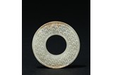 A SMALL GREEN JADE DISC BI
