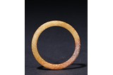A RUSSET JADE TWIST-ROPE BANGLE