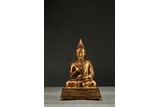 A GILT-BRONZE FIGURE OF LAMA