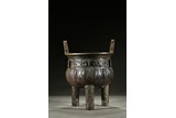 A BRONZE 'CICADA' TRIPOD VESSEL DING