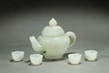 A SET OF WHITE JADE TEAPOT AND FOUR CUPS