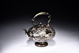 A VINTAGE SILVER TEAPOT