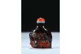 AN OPAQUE AMBER 'CHILONG' SNUFF BOTTLE