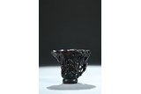 AN AGARWOOD CARVED 'CHILONG' LIBATION CUP