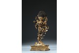 A GILT BRONZE FIGURE OF STANDING BUDDHIST DEITY