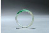 A WHITE AND GREEN JADEITE BANGLE