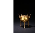 A GILT-BRONZE BRONZE TRIPOD CENSER