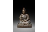 A BRONZE FIGURE OF SEATED LAMA