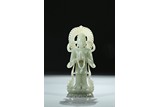 A CELADON JADE CARVING OF STANDING BODHISATTVA