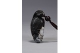A BLACK AND WHITE JADE CARVED PENDANT
