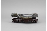 A BLACK JADE DRAGON-HEAD WASHER WITH STAND