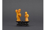 A BALTIC AMBER FIGURAL GROUP CARVING