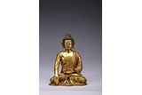 A GILT BRONZE FIGURE OF SHAKYAMUNI
