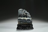 A BLACK AND WHITE JADE BOULDER WITH INSCRIPTION