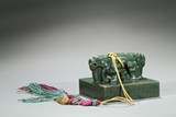 A SPINACH GREEN JADE 'INSCRIPTION' SEAL