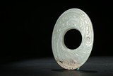 A JADE CARVED 'PHOENIX' OVAL DISC