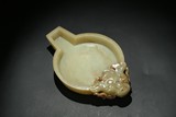 A CHINESE YELLOW JADE 'MYTHICAL BEAST' WASHER