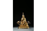 A GILT BRONZE FIGURE OF MANJUSRI AND LION