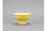 A LEMON-YELLOW GLAZED CUP
